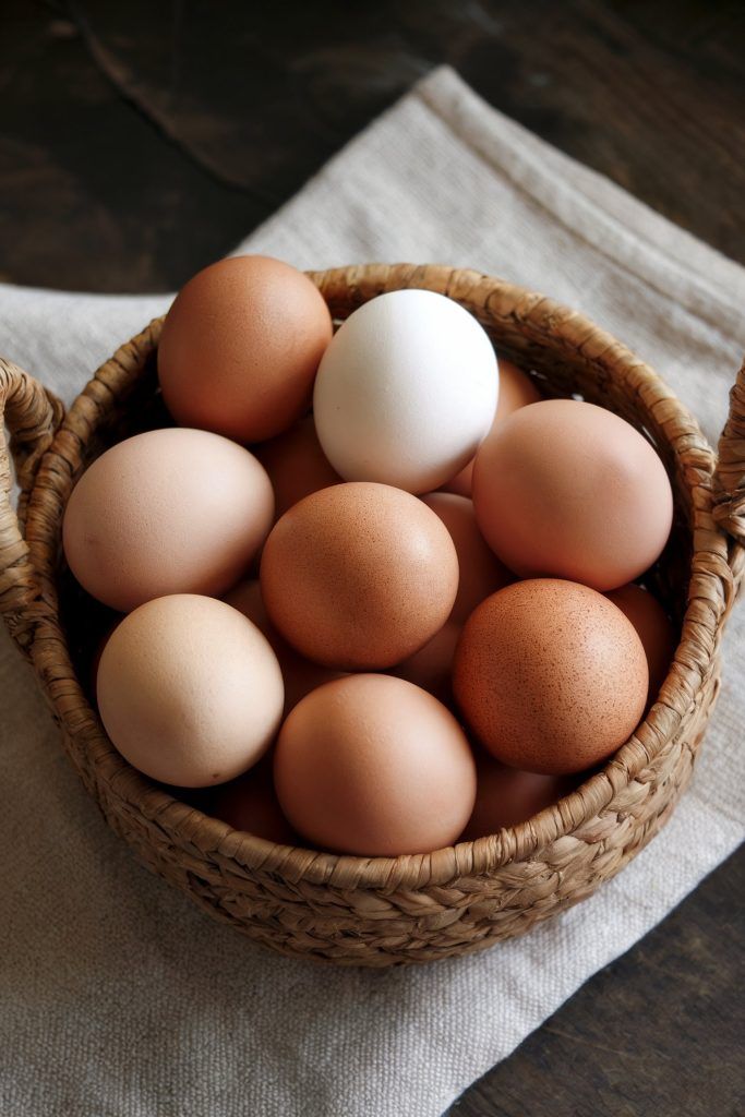 Freshly collected eggs gathered in a cloth-lined basket